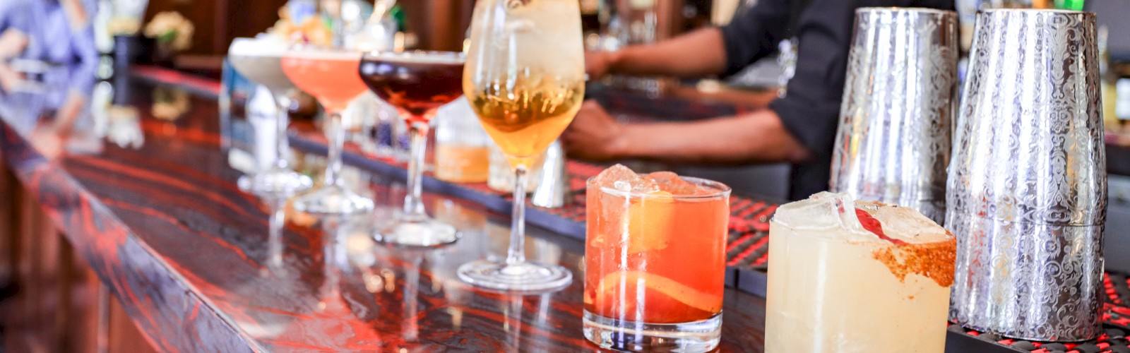 Cocktails lined up on a bar top