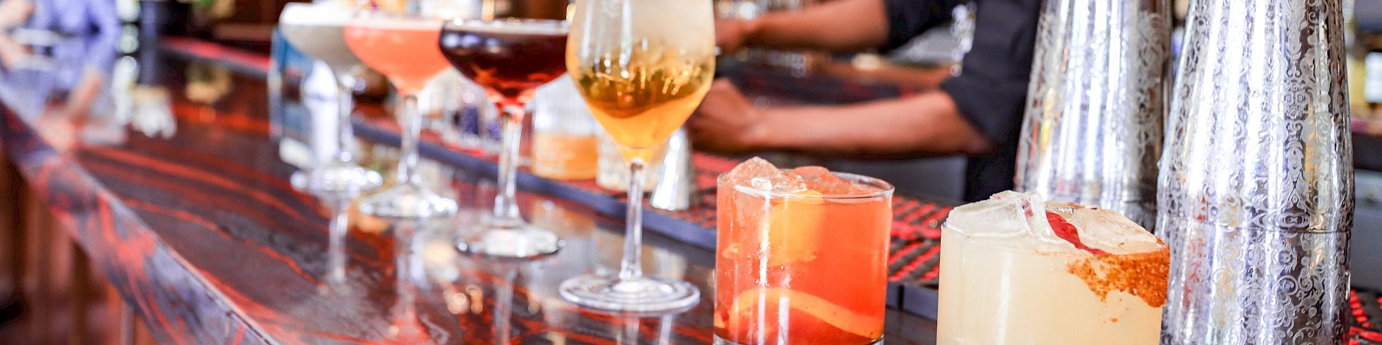 Cocktails lined up on a bar top