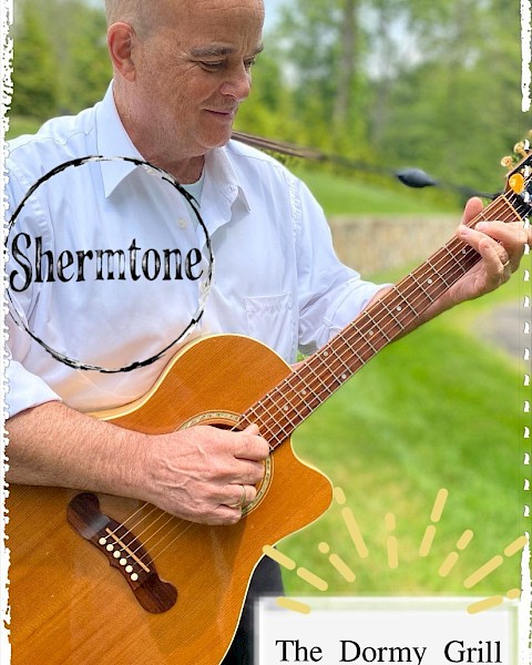 A person is playing a guitar outdoors, with 
