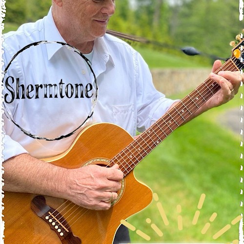 A person is playing a guitar outdoors, with 